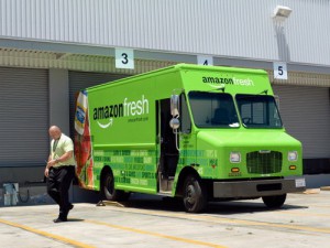 INGLEWOOD, CA - JUNE 27:  A man walk past an Amazon Fresh truck parked at a warehouse on June 27, 2013 in Inglewood, California. Amazon began groceries and fresh produce delivery on a trial basis to select Los Angeles neighberhoods free of charge for Amazon Prime members. AmazonFresh lets you order groceries and have them delivered on the same day.  (Photo by Kevork Djansezian/Getty Images)